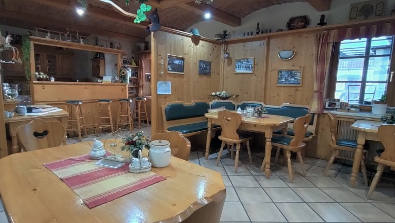 Cozy breakfast room with wooden furniture and decorations.