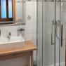 Modern bathroom with shower, washbasin and mirror.