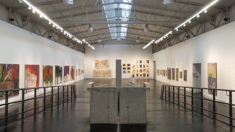 Interior view of the Nitsch Museum with paintings on the walls and modern architecture.