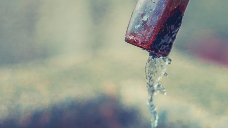 Close-up of a drinking fountain with flowing water from a metal pipe.