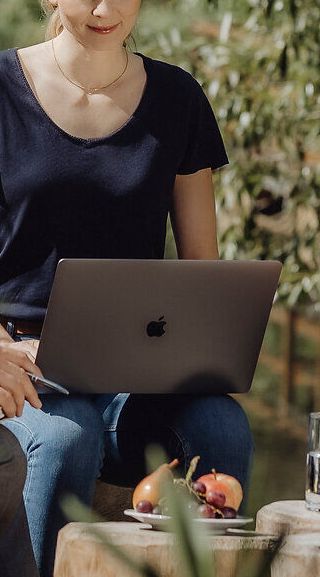 Umgeben von üppigem Grün und dem sanften Plätschern eines nahegelegenen Gewässers, genießen drei Freunde eine entspannte Auszeit in der Natur. Mit einem Laptop auf dem Tisch und einer Tasse Kaffee in der Hand, wird hier die perfekte Balance zwischen Arbeit und Erholung gefunden. Die idyllische Kulisse lädt dazu ein, die Seele baumeln zu lassen und die Schönheit der Umgebung zu erleben.